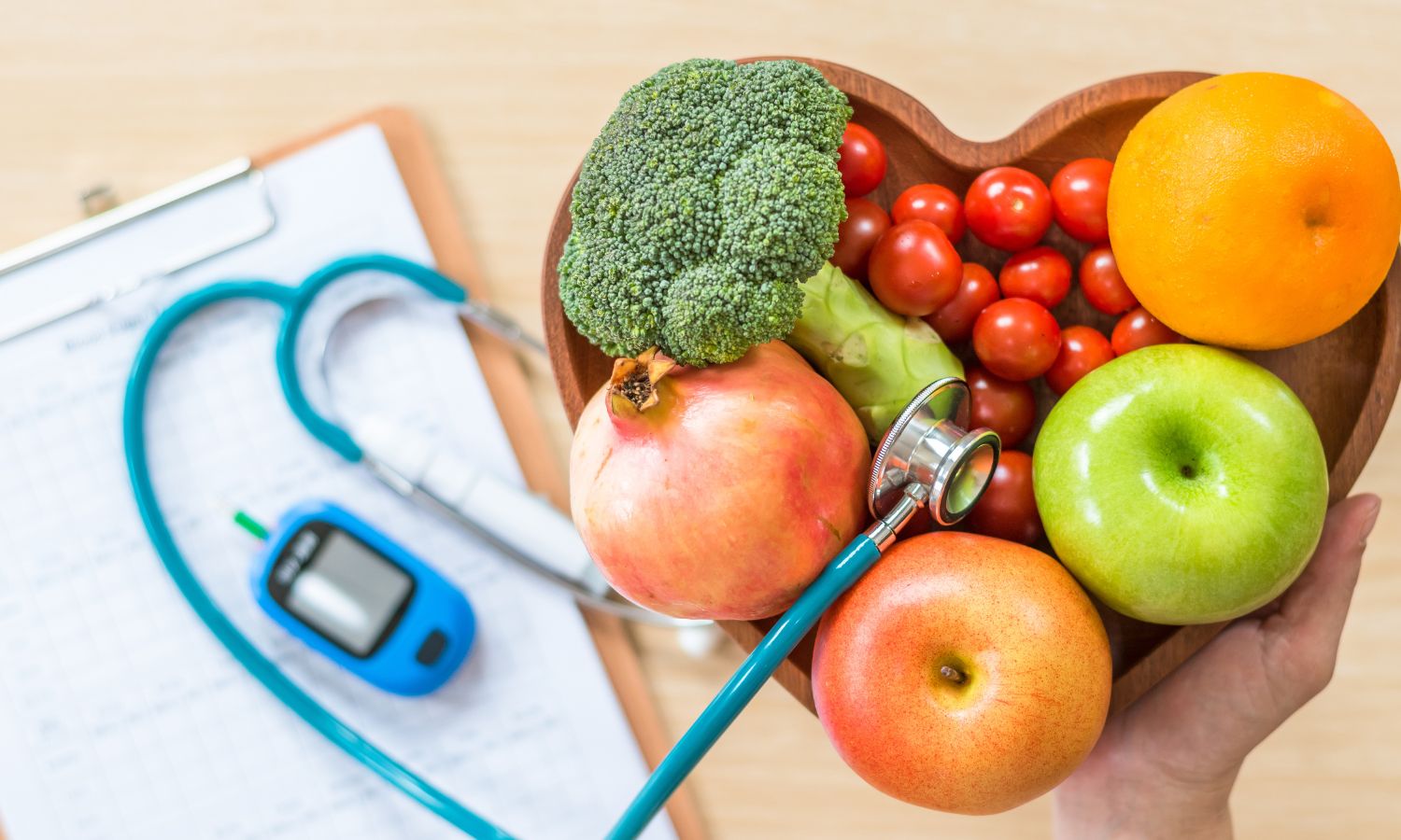 Heart shaped bowl of fruit next to a blood sugar monitor