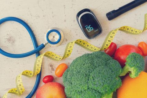 Fruit, vegetables and a measuring tape on a table